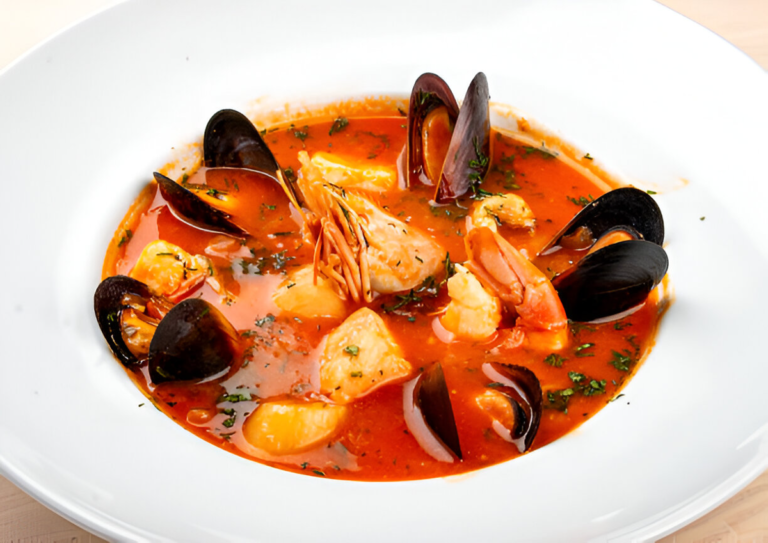 Zuppa di Pesce alla Napoletana con frutti di mare, pomodori e basilico fresco in una ciotola rustica